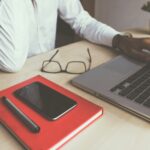 man typing on laptop computer