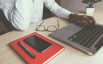man typing on laptop computer