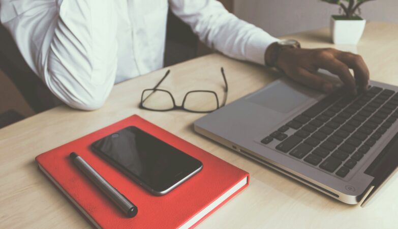 man typing on laptop computer