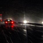 Cars driving on a wet road at night
